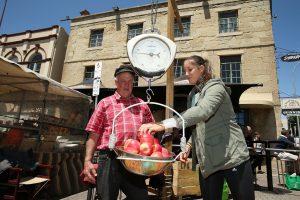 Brit Laura Robson weighs some apples at Hobart's Salamanca Place