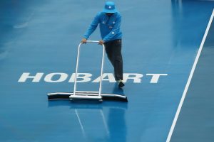 Rain delayed play for over two hours, leaving officials the job of drying the court. Picture: Getty Images