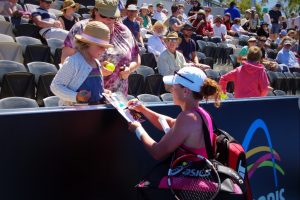 Crowd favourite and top seed Samantha Stosur signs an autograph for a fan after her quarter-final victory. Picture: Casey Gardner