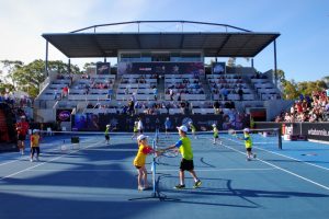 Some local MLC Tennis Hot Shots juniors have a hit on centre court between matches at the Domain Tennis Centre. Picture: Casey Gardner