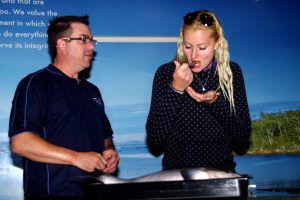Frenchwoman Kristina Mladenovic tries some of Tassal's salmon at The Salmon Shop in Hobart's Salamanca Place. Picture: Casey Gardner