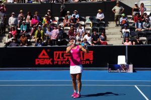 A happy Samantha Stosur hits prizes donated by The Old Woolstore Apartment Hotel into the crowd after her win. Picture: Casey Gardner