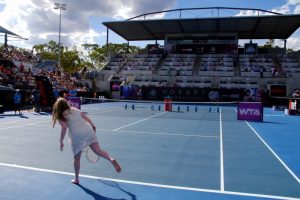 Crowd members put their serving skills to the test on centre court between matches. Picture: Casey Gardner