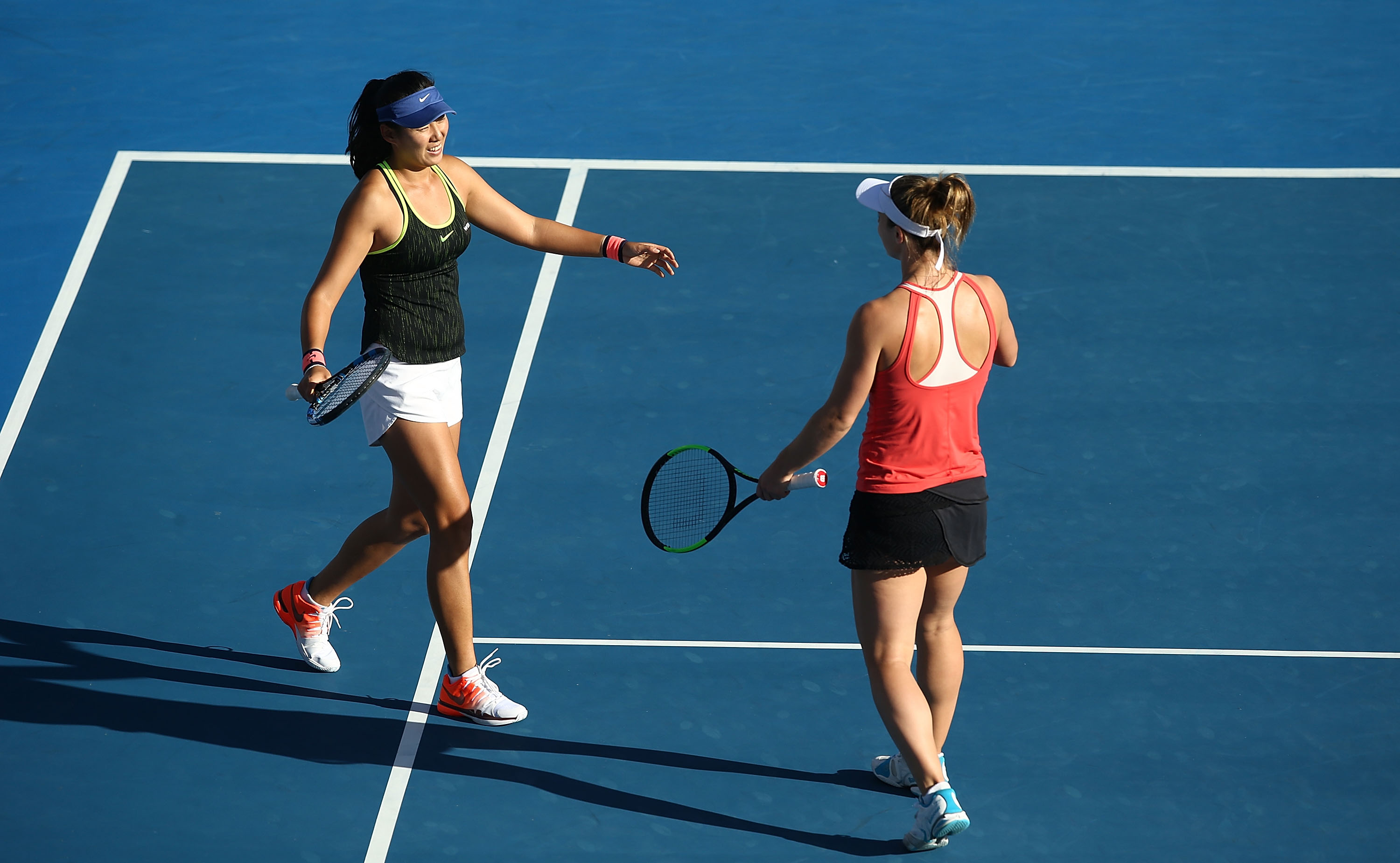 EXCITEMENT: Zhaoxuan Yang of China and Gabriela Dabrowski of Canada embrace after winning their doubles semifinal; Getty Images