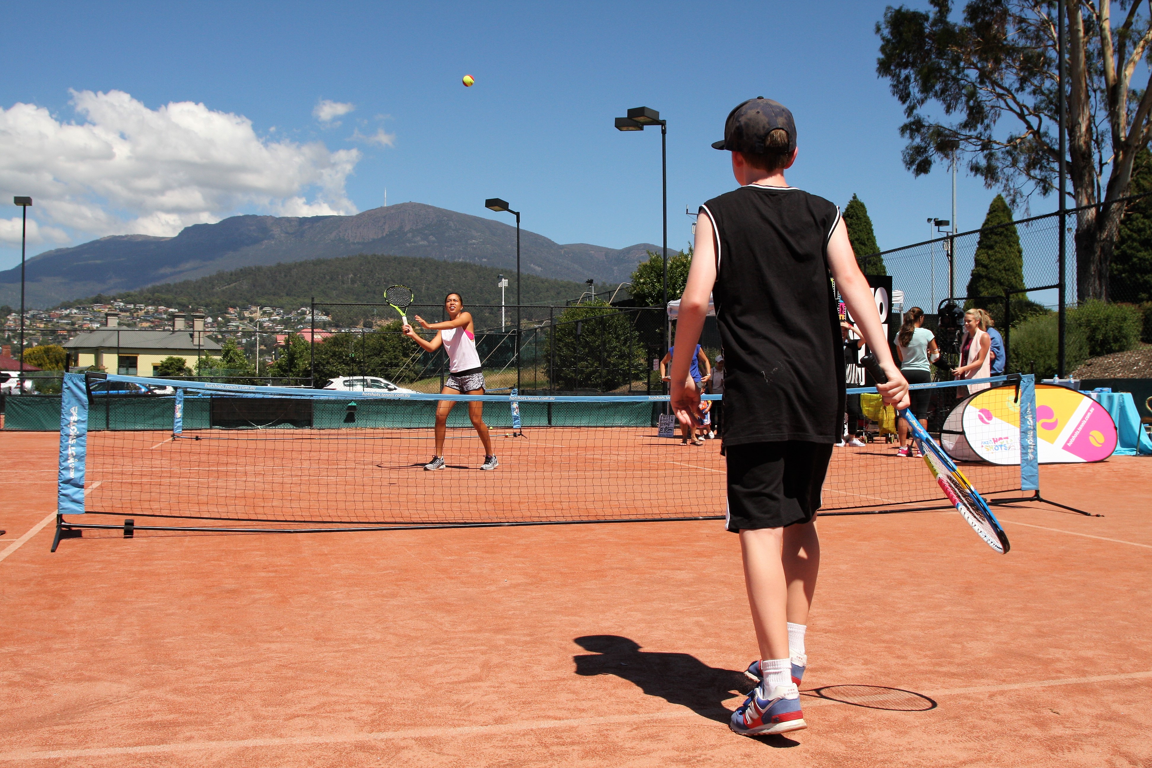 NEW EXPERIENCE: The kids lined up for the chance to hit with Australian player Lizette Cabrera.